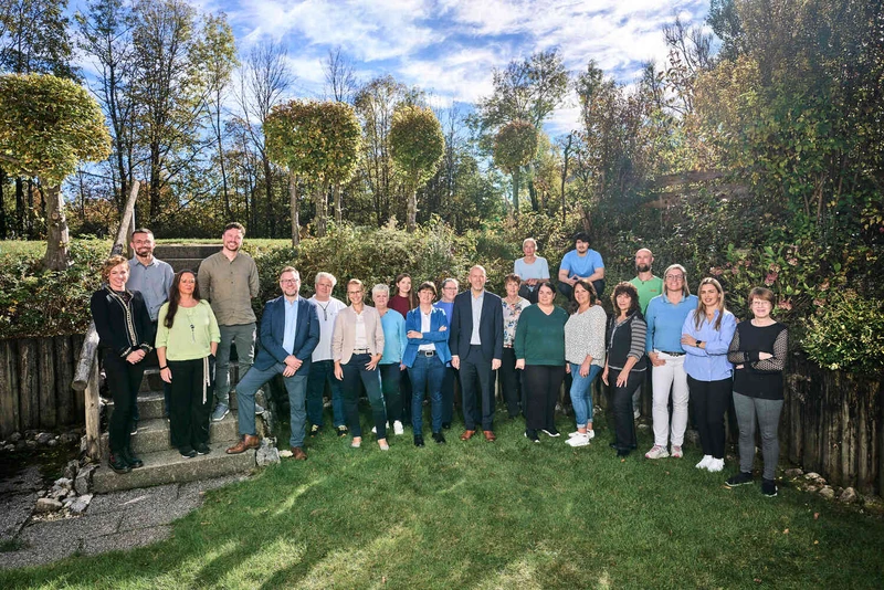 Gruppe von Mitarbeitenden der Oberberg Fachklinik Bad T&ouml;lz steht gemeinsam im Garten