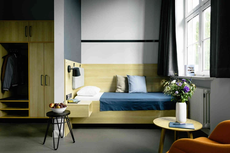 Patientenzimmer mit Bett und kleinem Tisch