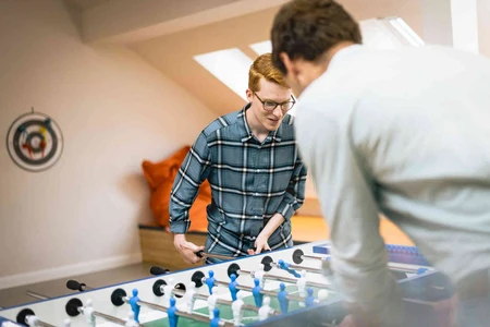 Zwei Personen spielen Tischkicker