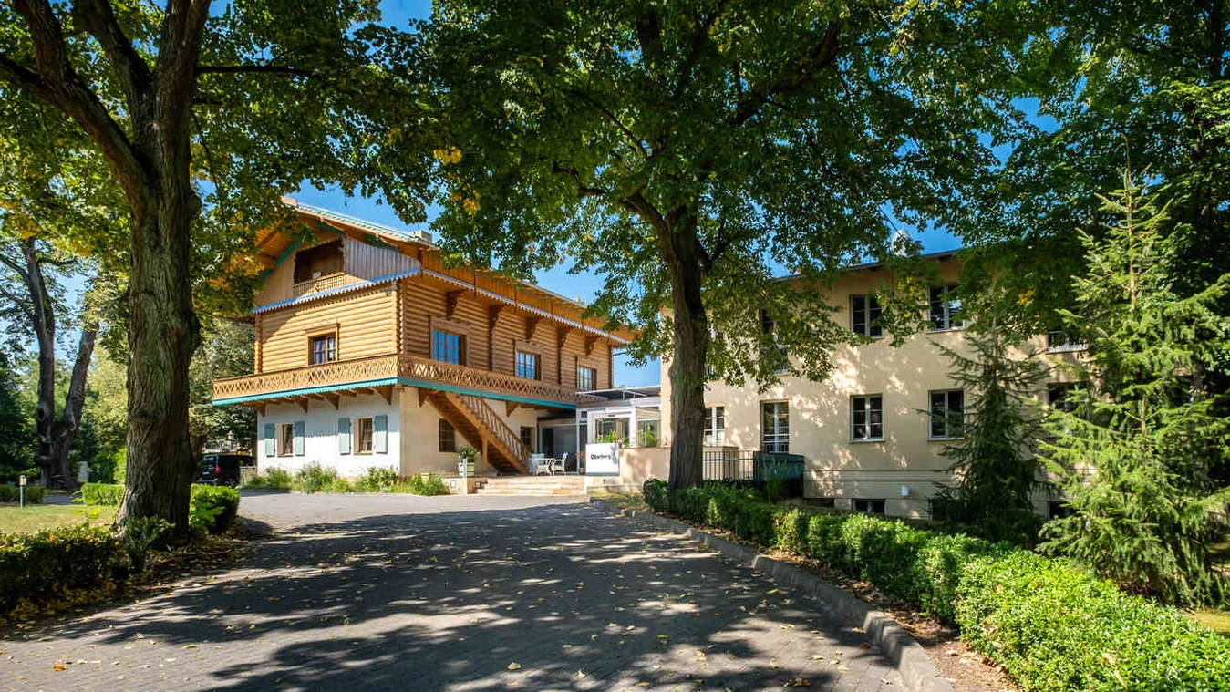 Au&szlig;enansicht der Oberberg Fachklinik Potsdam mit historischem Geb&auml;ude und B&auml;umen